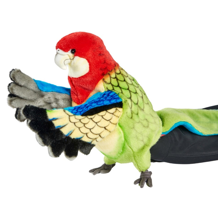 Golden-mantled rosella hand puppet by Hansa Creation with a red head, yellow-green scalloped plumage and blue wing edges