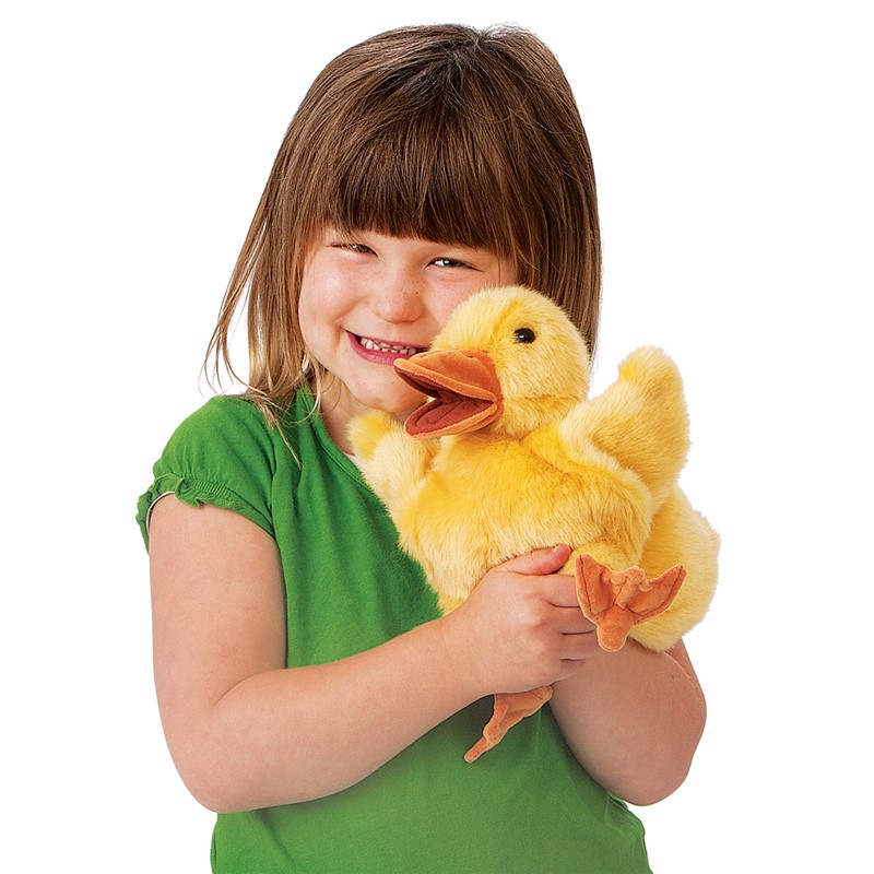 Folkmanis duckling hand puppet in yellow with an orange beak, held by a smiling girl, with a movable beak