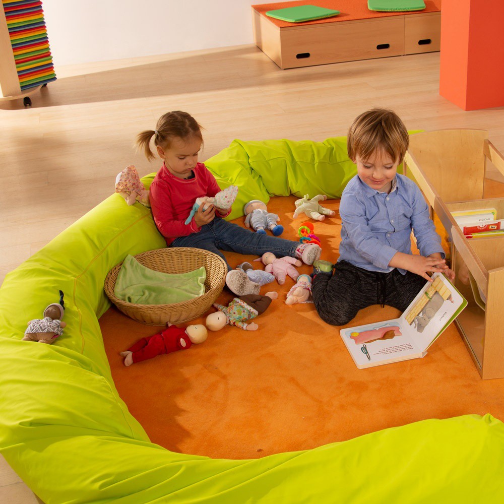 Children playing with the dolls of the Joyk Treasure Basket set in a play corner