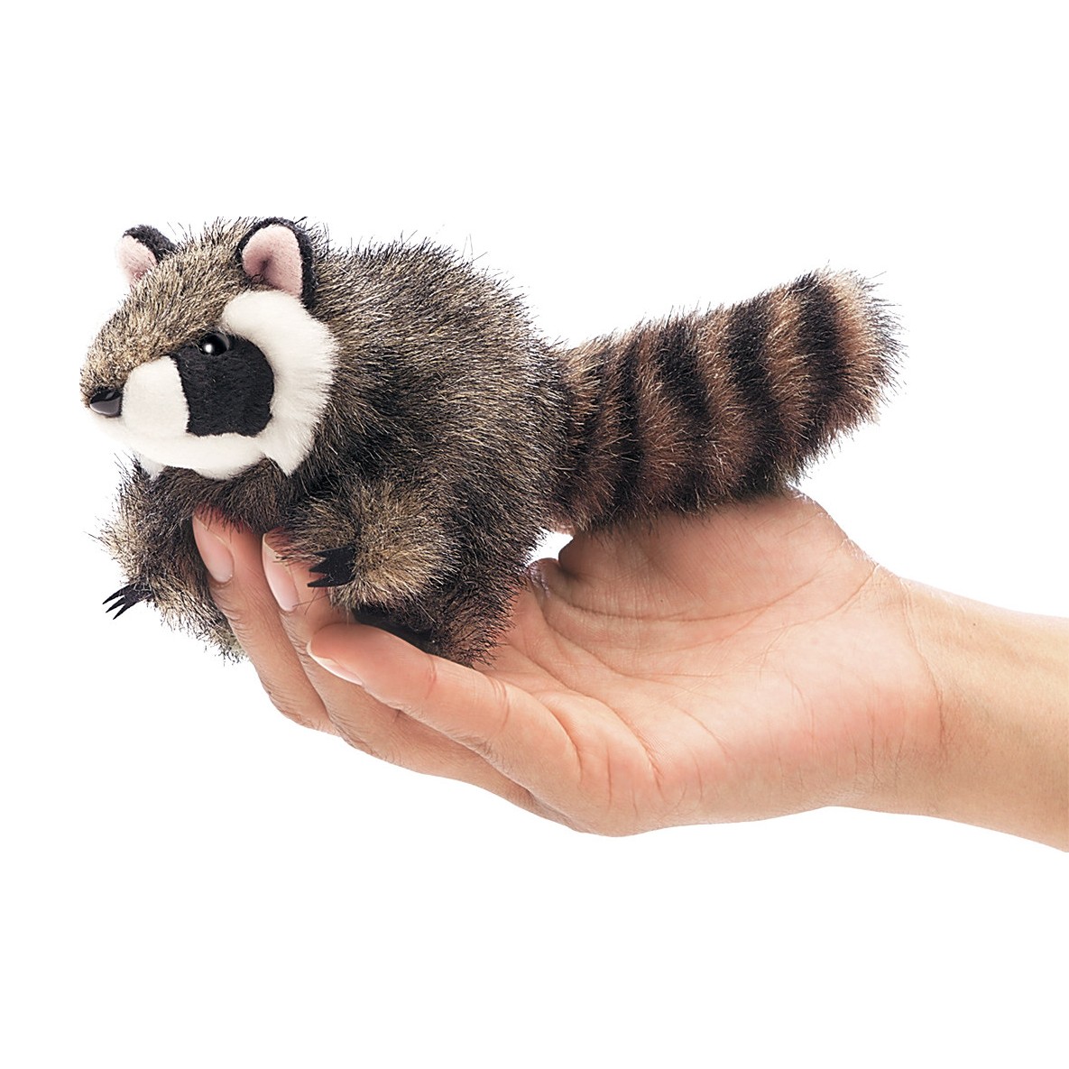 Folkmanis mini raccoon finger puppet with ringed tail, lying on a hand, side view
