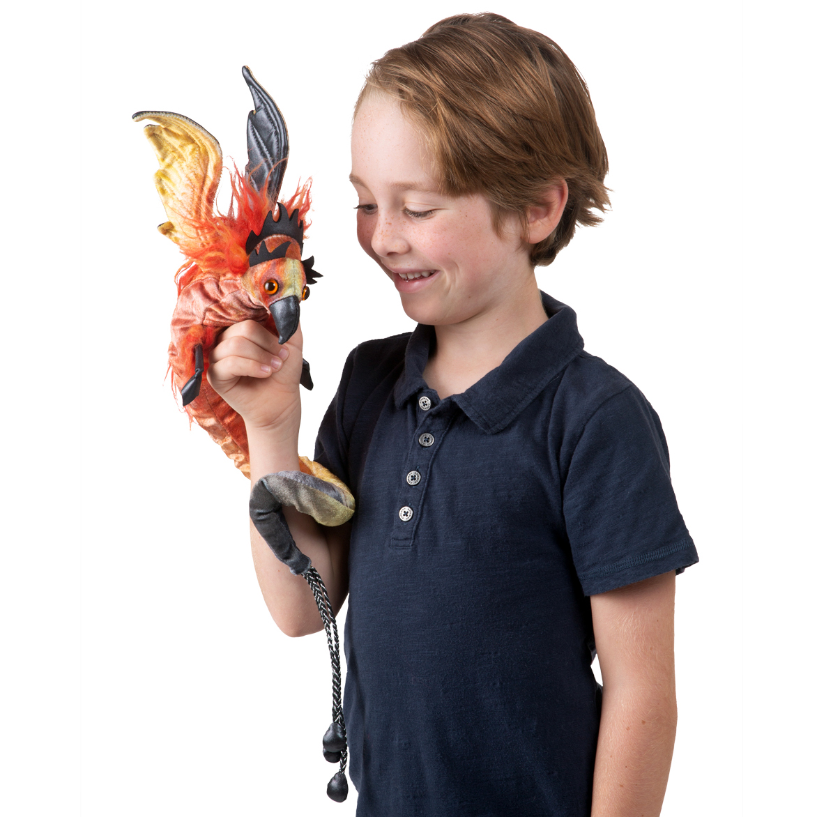 Folkmanis finger puppet phoenix with red plumage and dark wings, worn by a boy on his outstretched arm