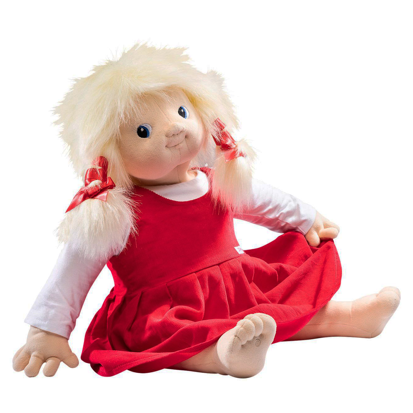 Joyk empathy doll Nelly with blond pigtails, white shirt and red pinafore dress, sitting
