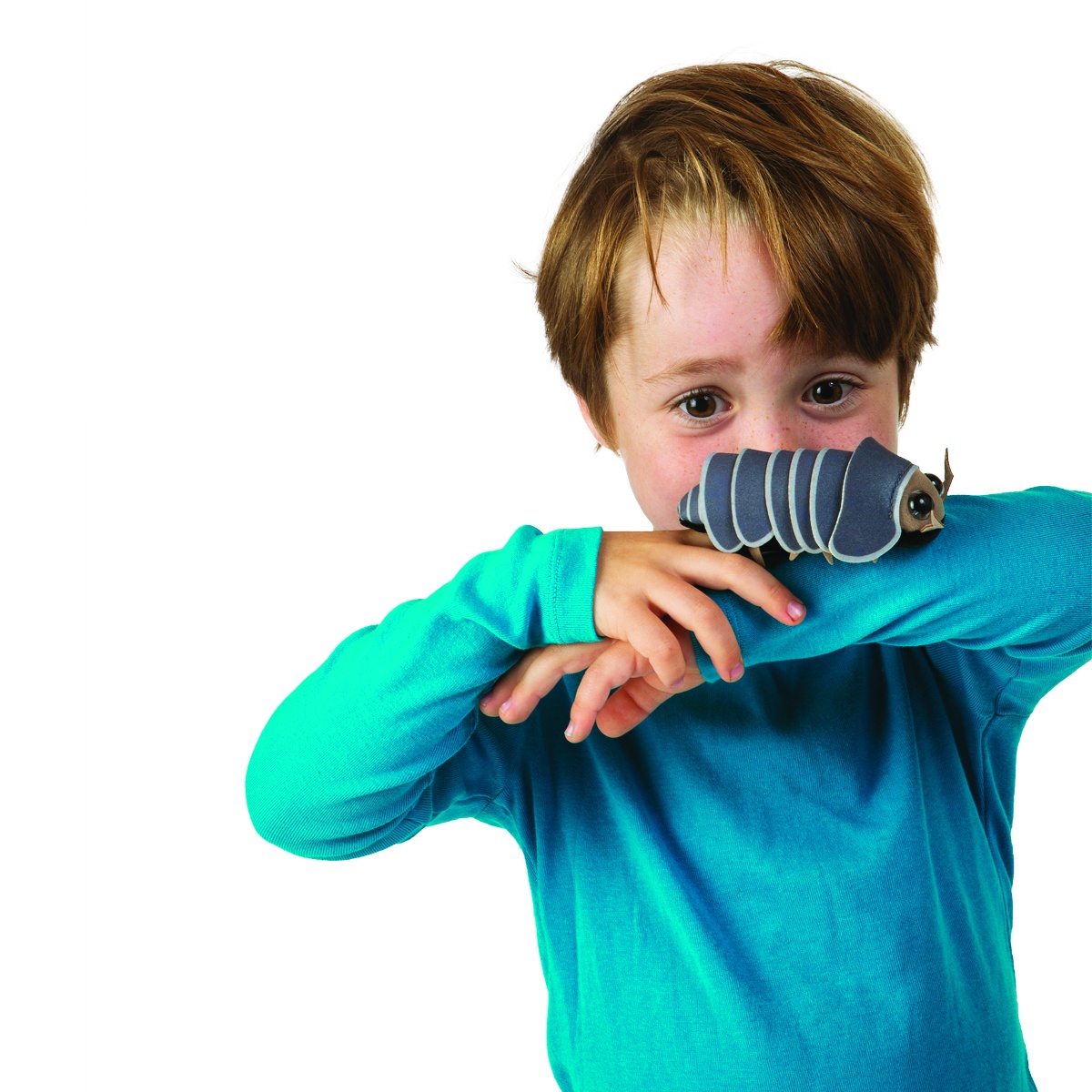 Boy in a turquoise jumper holding a grey Folkmanis woodlouse finger puppet with a segmented back against his arm