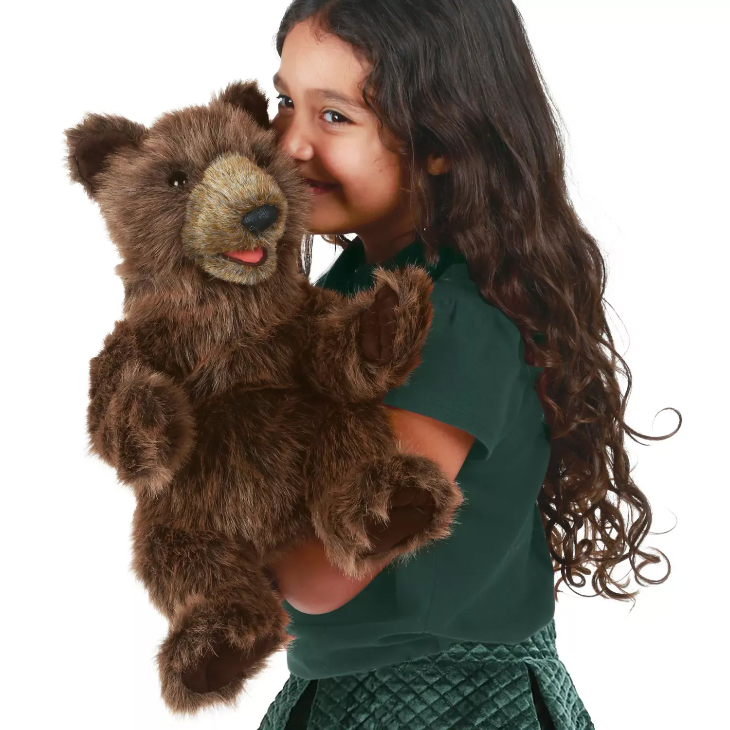 Girl holding a Folkmanis bear cub hand puppet with dark brown plush fur and an open mouth close to her face