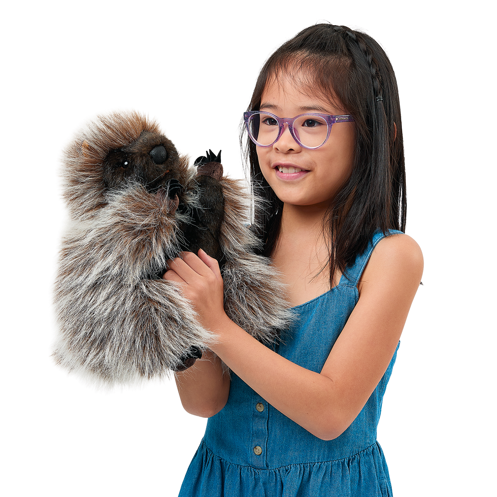 Folkmanis standing porcupine hand puppet on a girl's arm, the claws on its front paws clearly visible.