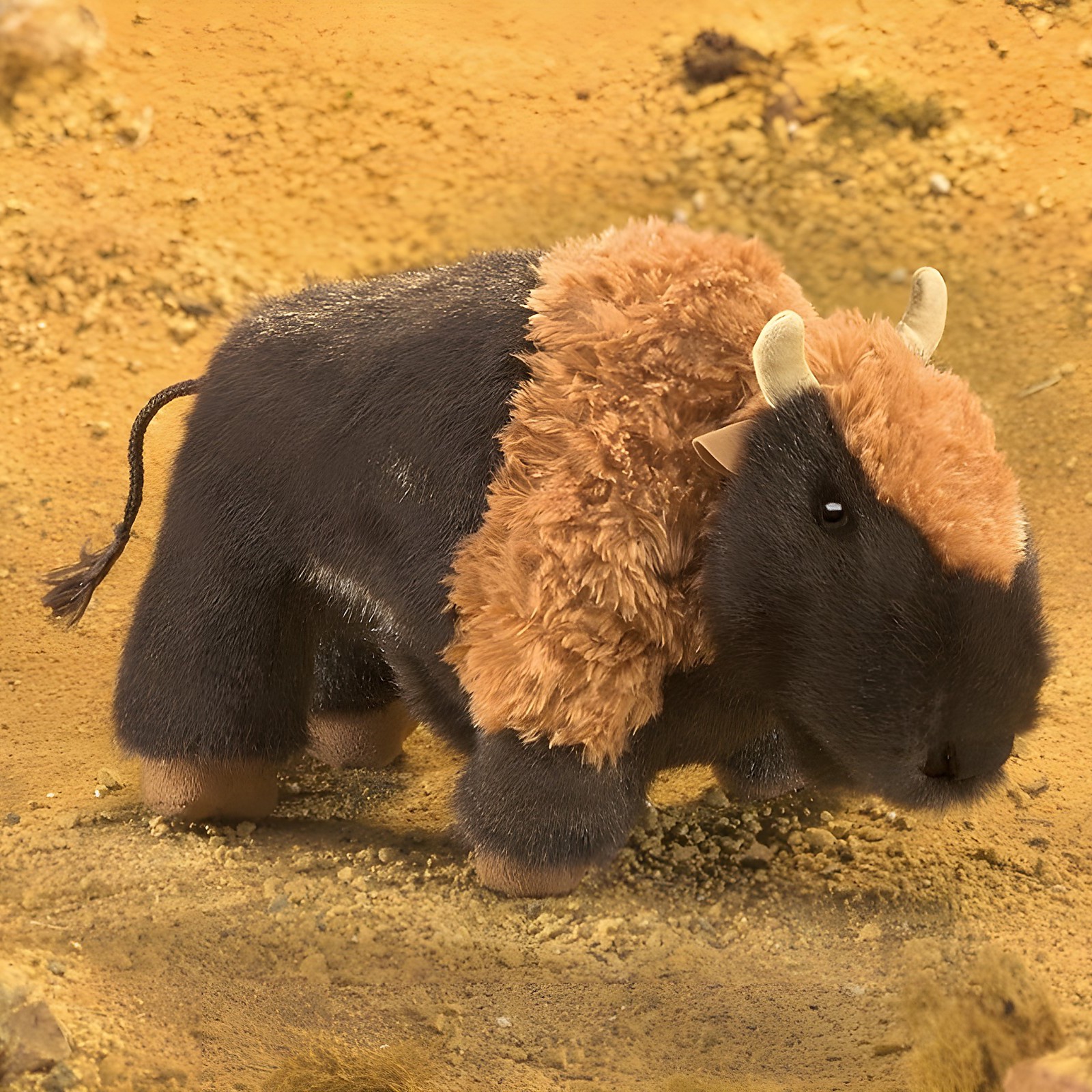 Folkmanis hand puppet small bison in side view with dark grey body and curly brown fur on the hump
