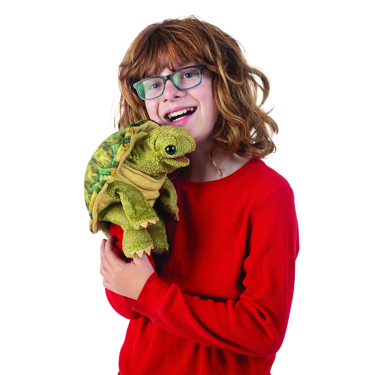 Child holding the Folkmanis standing tortoise hand puppet with green scaly texture and open mouth towards the camera