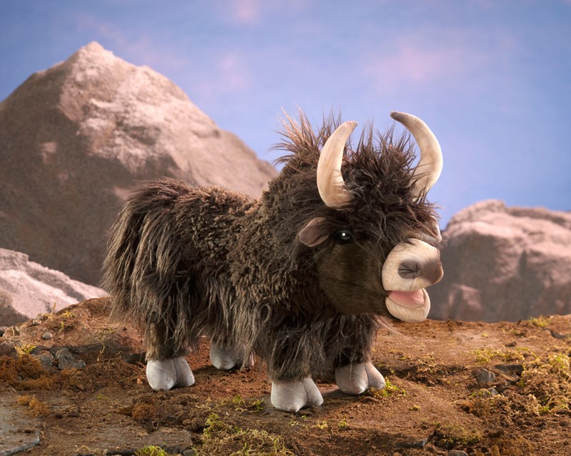Folkmanis yak hand puppet with shaggy dark brown fur, curved horns, and movable mouth shown from the side