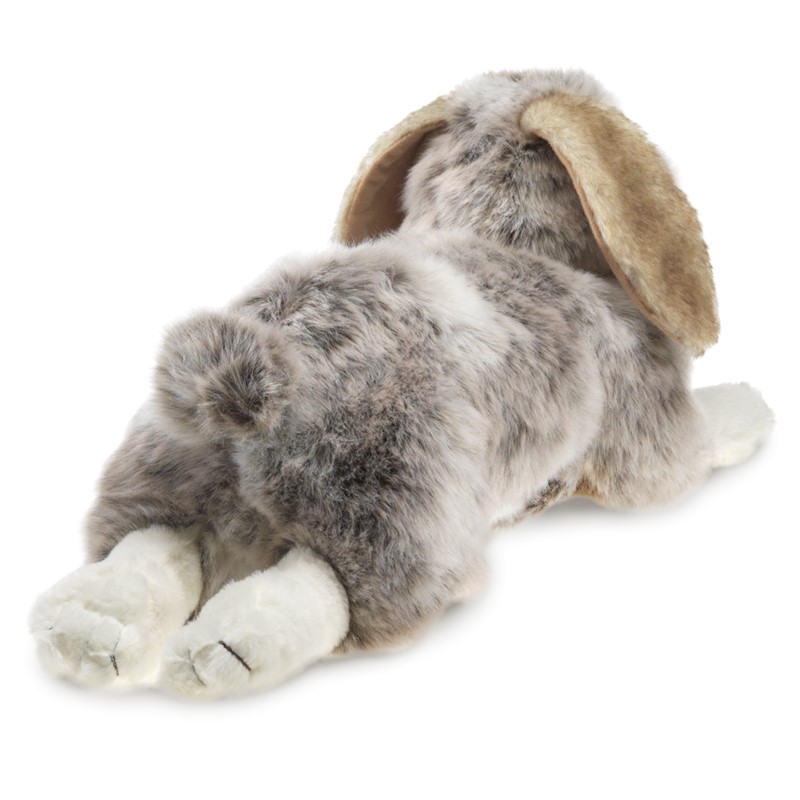 Folkmanis Holland Lop rabbit hand puppet lying down, grey-white mottled fur with beige floppy ears, angled view