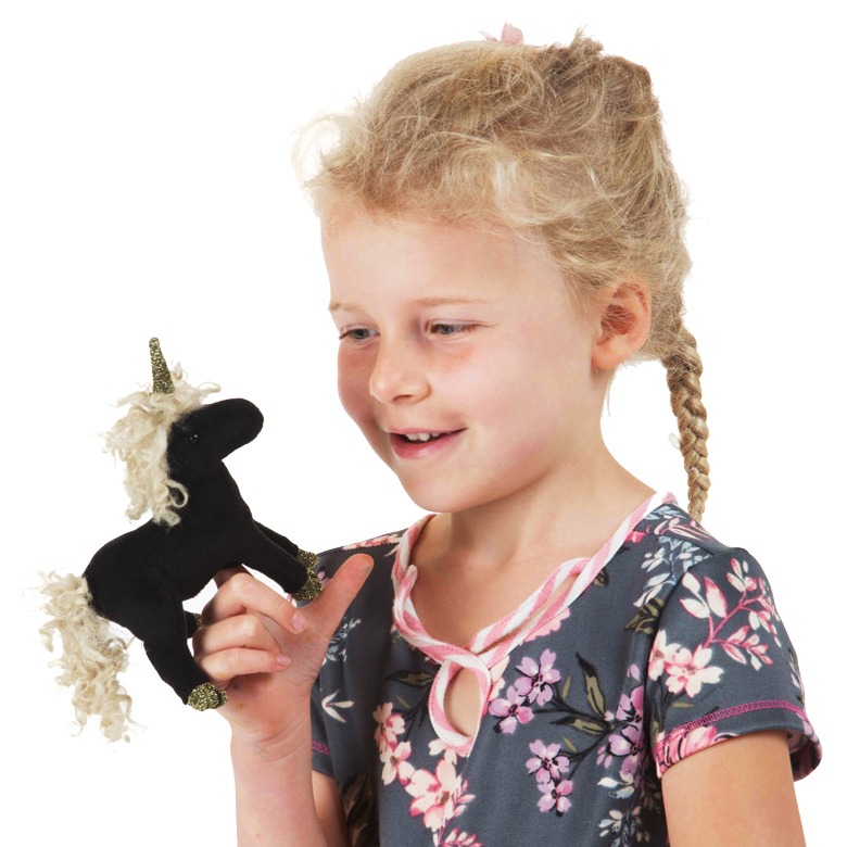 Girl holding a Folkmanis mini black unicorn finger puppet with a golden horn and curly mane on her finger