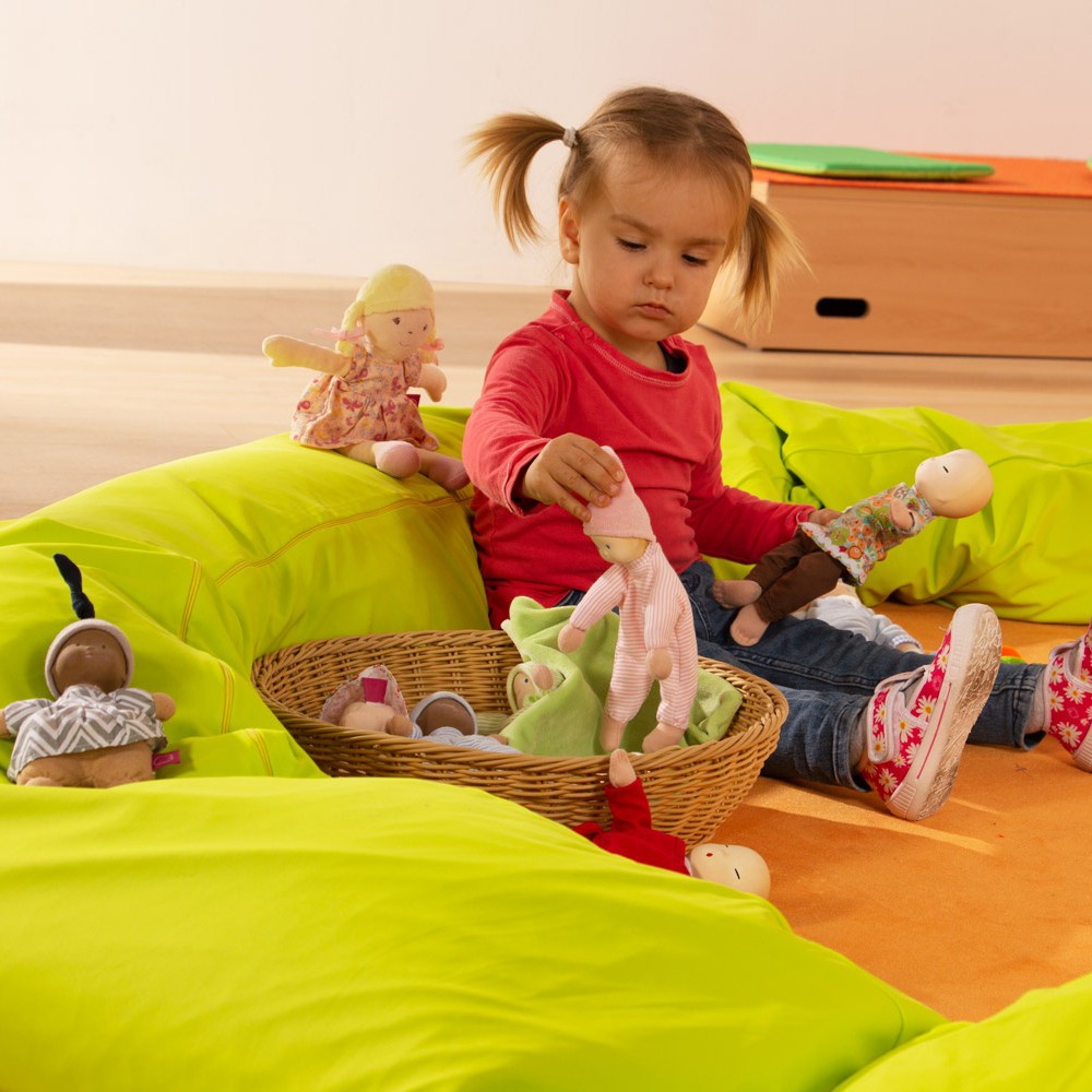 Toddler playing with the small fabric dolls from the Joyk Treasure Basket set
