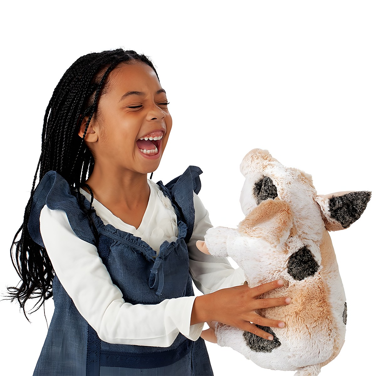 Laughing girl holding the Folkmanis grunting pig hand puppet with beige fur and dark spots in her hands