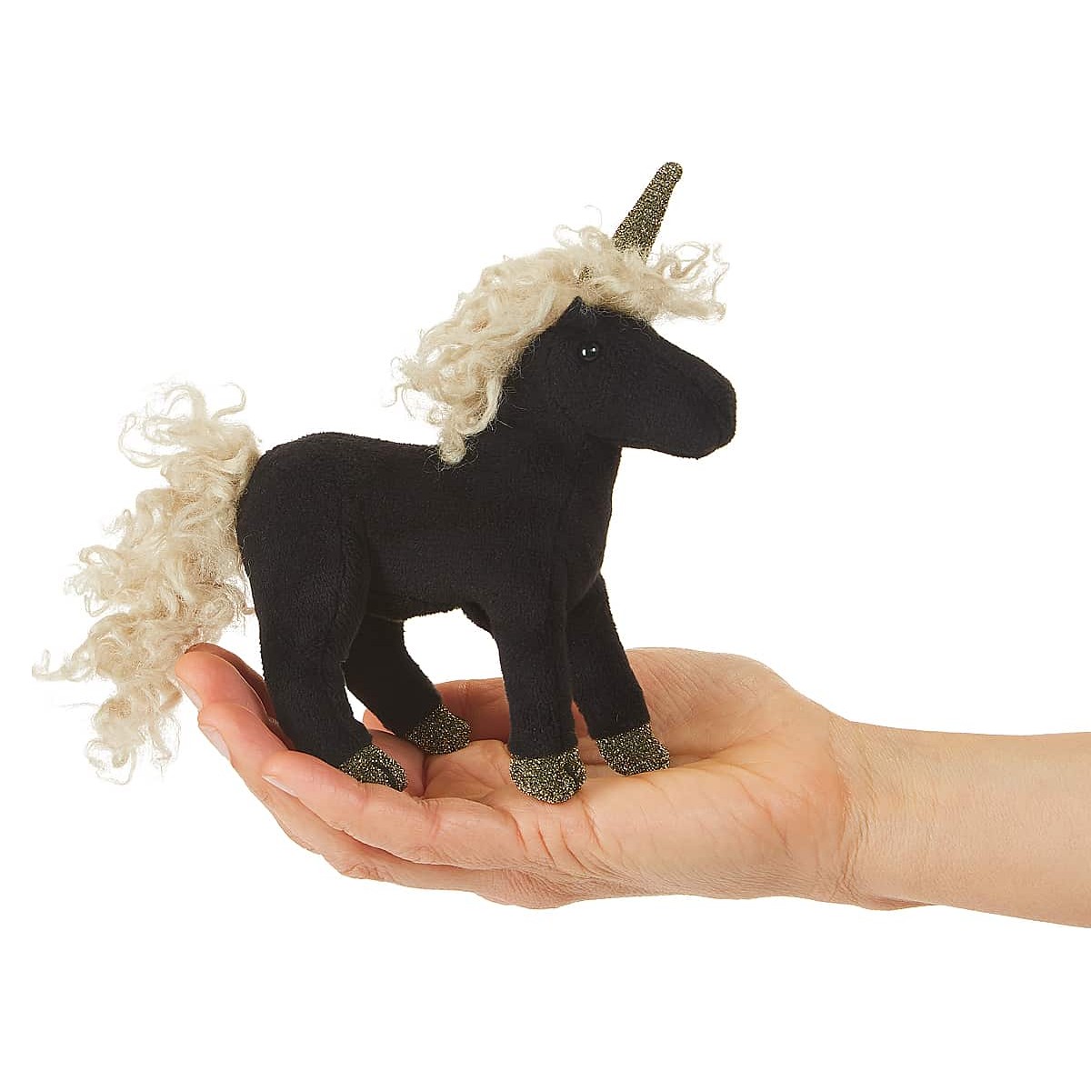 Folkmanis mini black unicorn finger puppet with creamy curly mane, gold glitter horn and hooves, standing on a palm