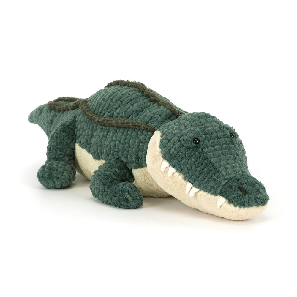 Jellycat plush toy alligator Allexi with dark green ribbed fur, a cream-coloured belly and a long snout, lying down
