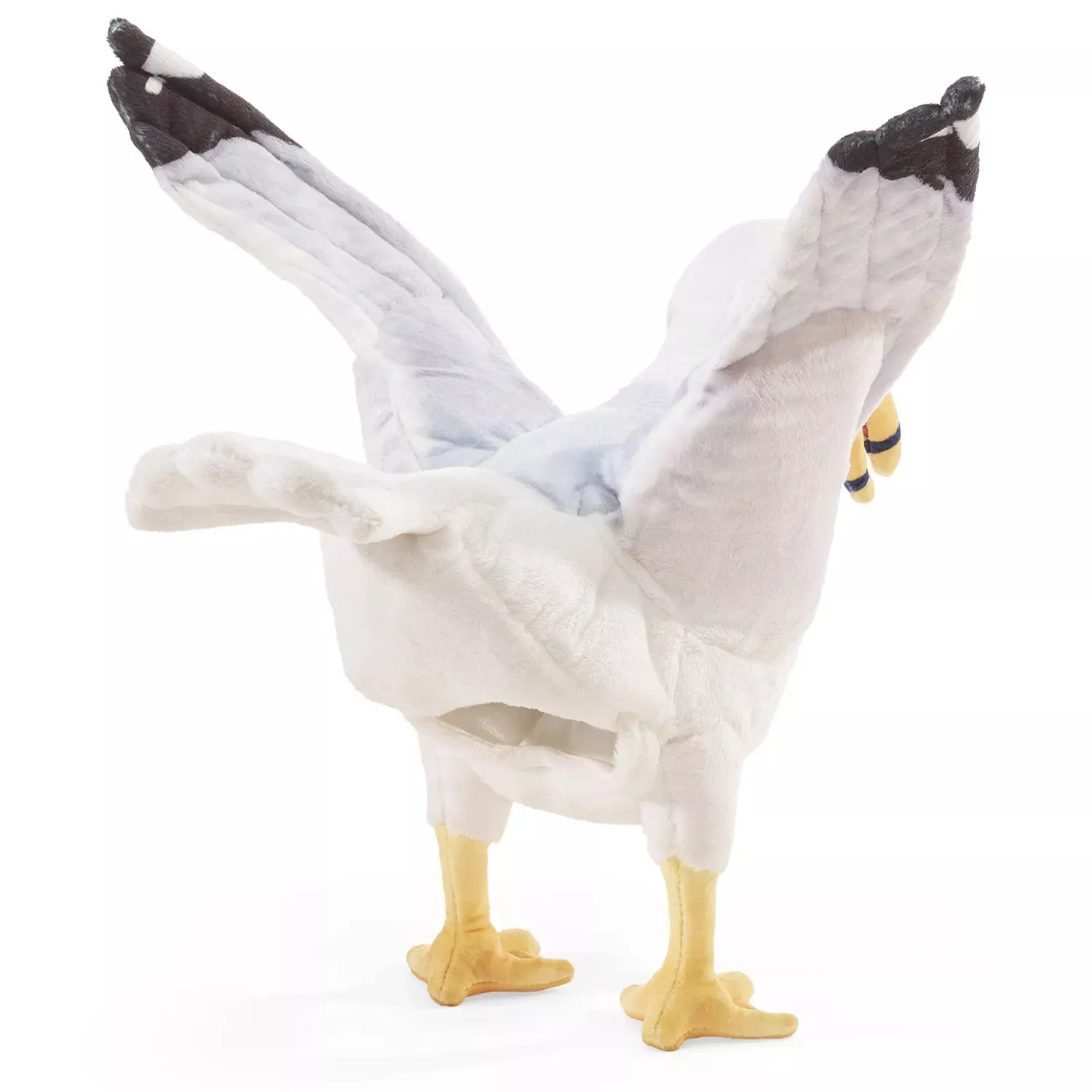 Folkmanis seagull hand puppet seen from behind with spread wings, grey-white plush and yellow webbed feet
