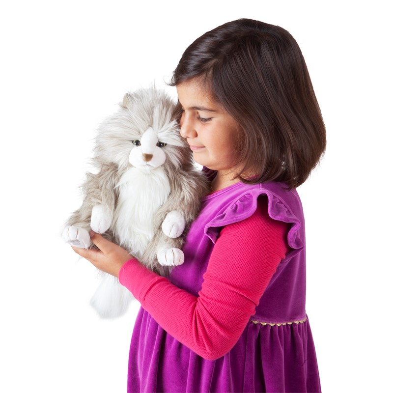 Girl holding the Folkmanis fluffy cat hand puppet with grey and white long fur snuggled against her face