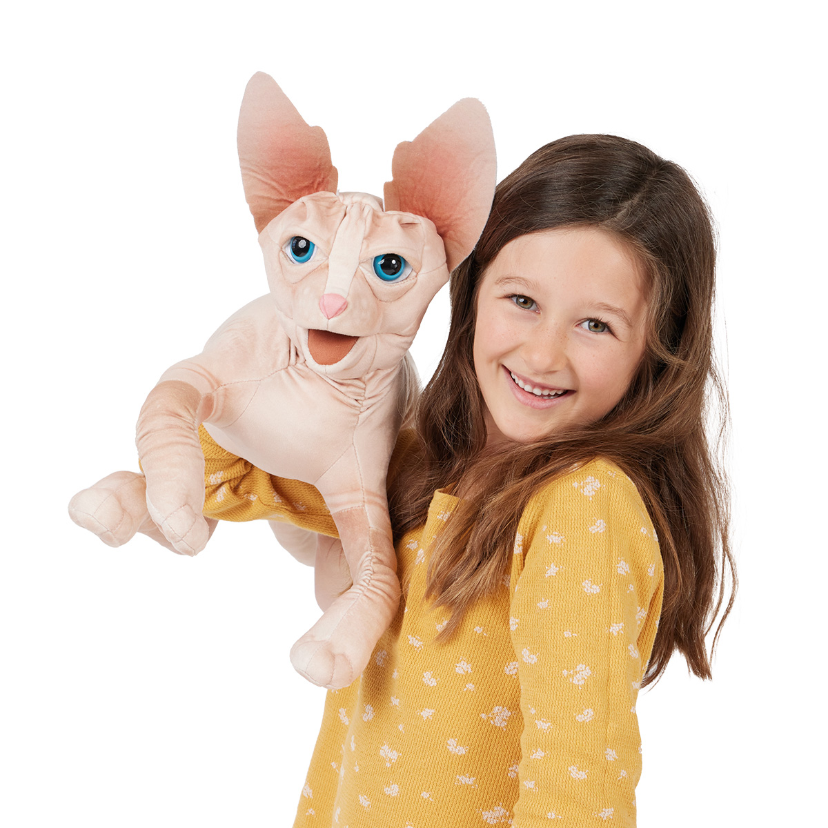 Girl holding a Folkmanis Sphynx cat hand puppet with large ears, blue eyes and wrinkled skin up to the camera
