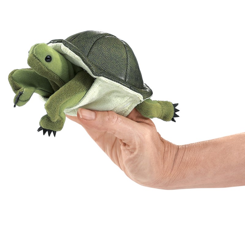 Folkmanis mini turtle finger puppet in green on a hand, with textured shell and movable head