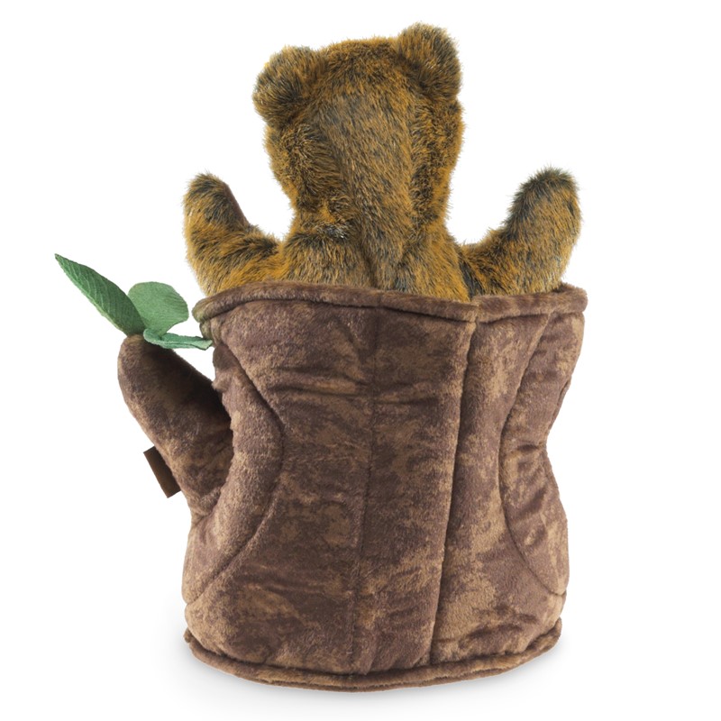 Folkmanis Bear in Tree Stump hand puppet, rear view: brown-golden bear cub peeking out of a plush tree stump with a green leaf