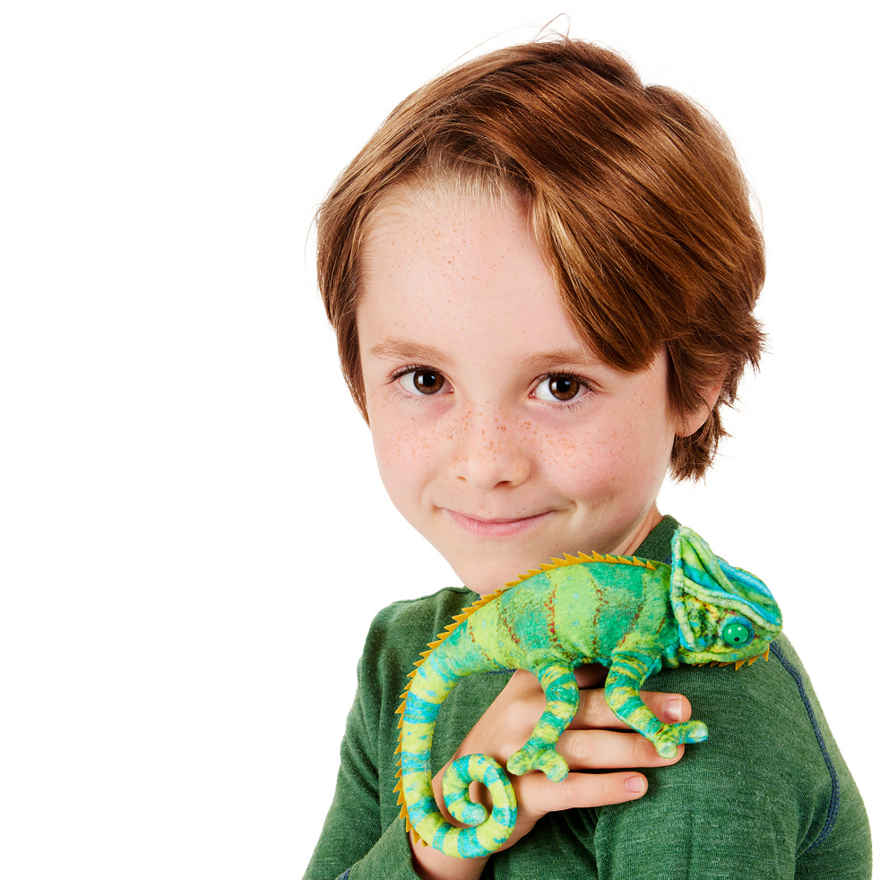 Folkmanis mini chameleon finger puppet in green and turquoise held in a boy's hand, side view