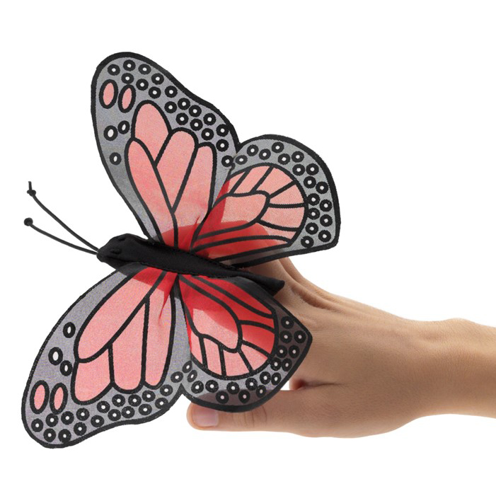 Folkmanis mini monarch butterfly finger puppet with pink-and-black wings, worn on a finger, side view