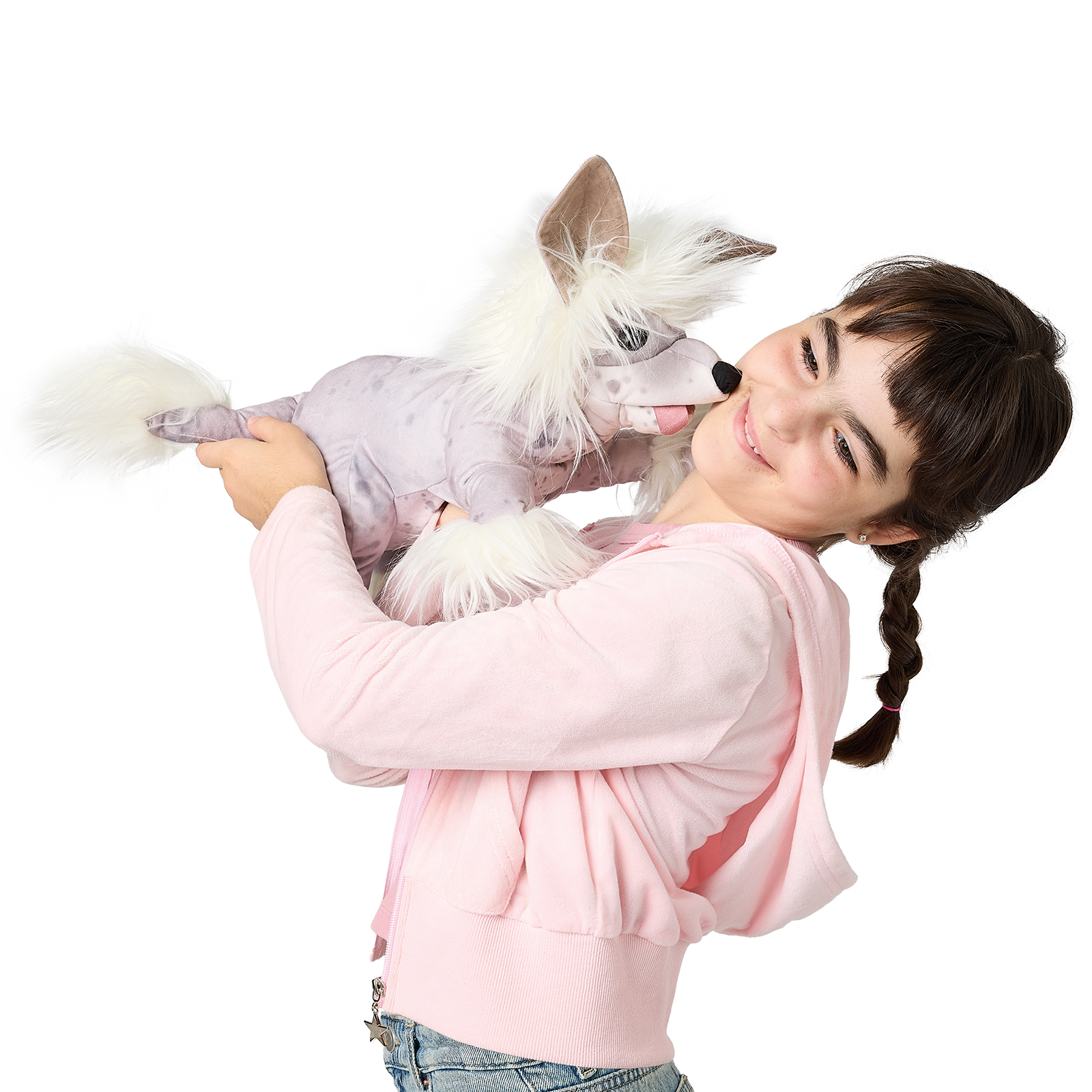 Girl smiling and holding a Folkmanis Chinese Crested Dog hand puppet with white fur and a grey-lilac body up in the air