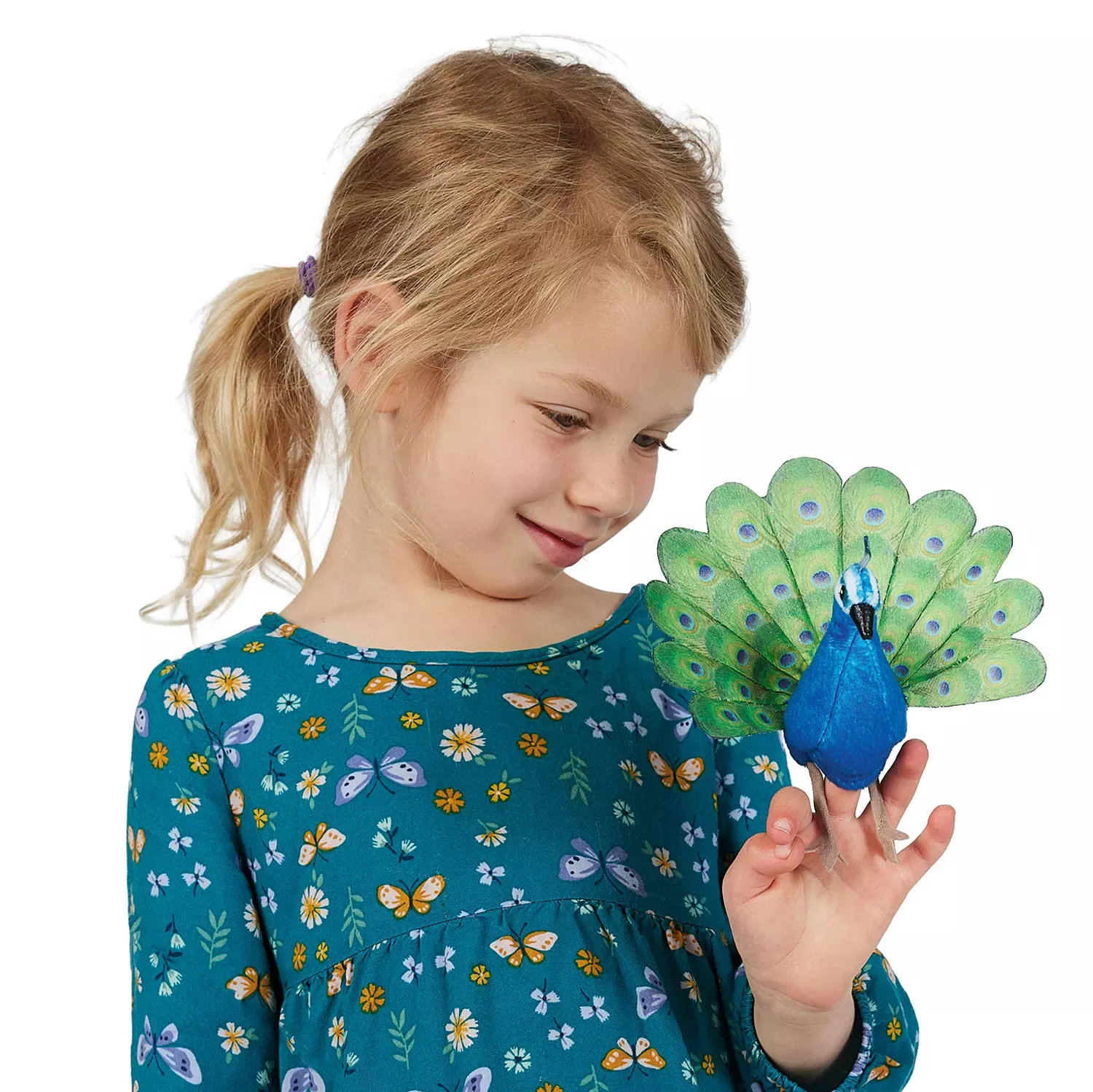 Girl wearing the Folkmanis mini peacock finger puppet with a blue body and green patterned tail on her index finger