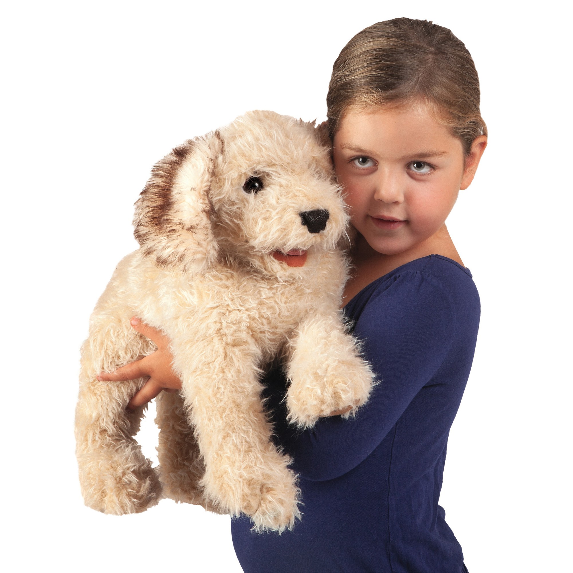 Girl holding the Folkmanis Labradoodle hand puppet with cream curly fur and brown ears in her arms