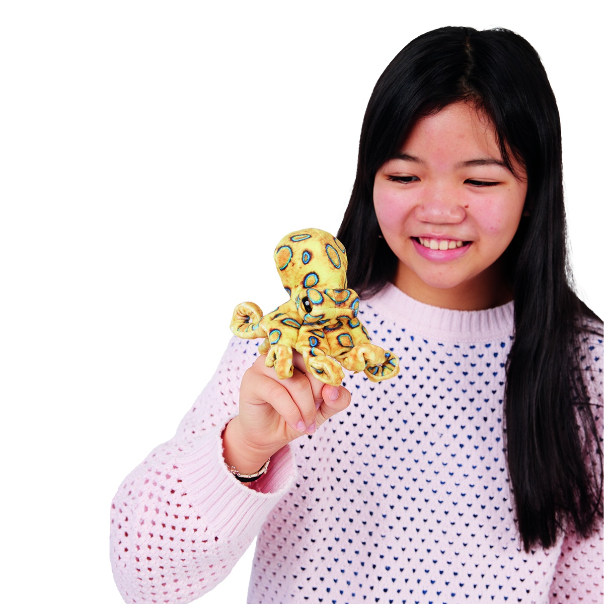 Smiling girl holding the Folkmanis mini blue-ringed octopus finger puppet on her index finger, yellow with blue rings, front view
