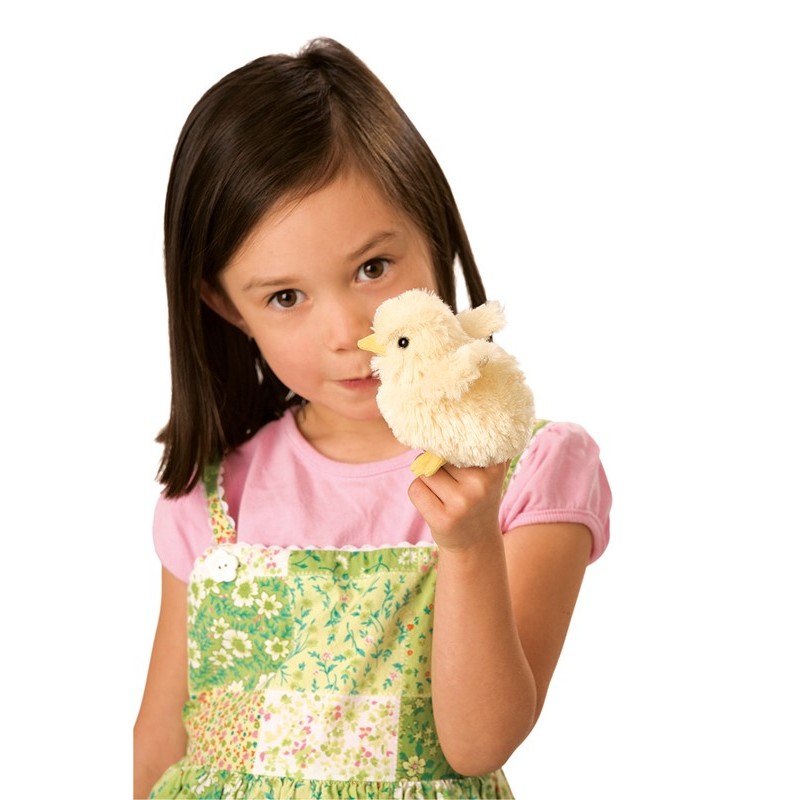 Girl holding a Folkmanis mini chick finger puppet in cream white with a yellow beak close to her face