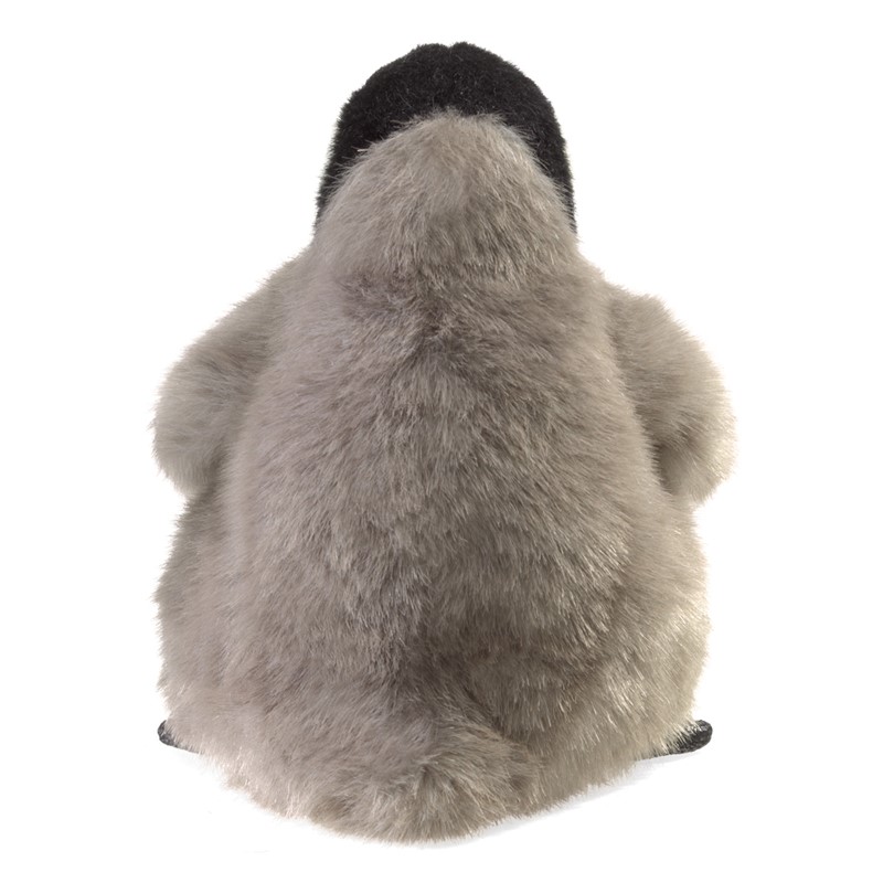 Folkmanis Baby Emperor Penguin hand puppet seen from behind: fluffy grey plumage, black cap on head, sitting pose