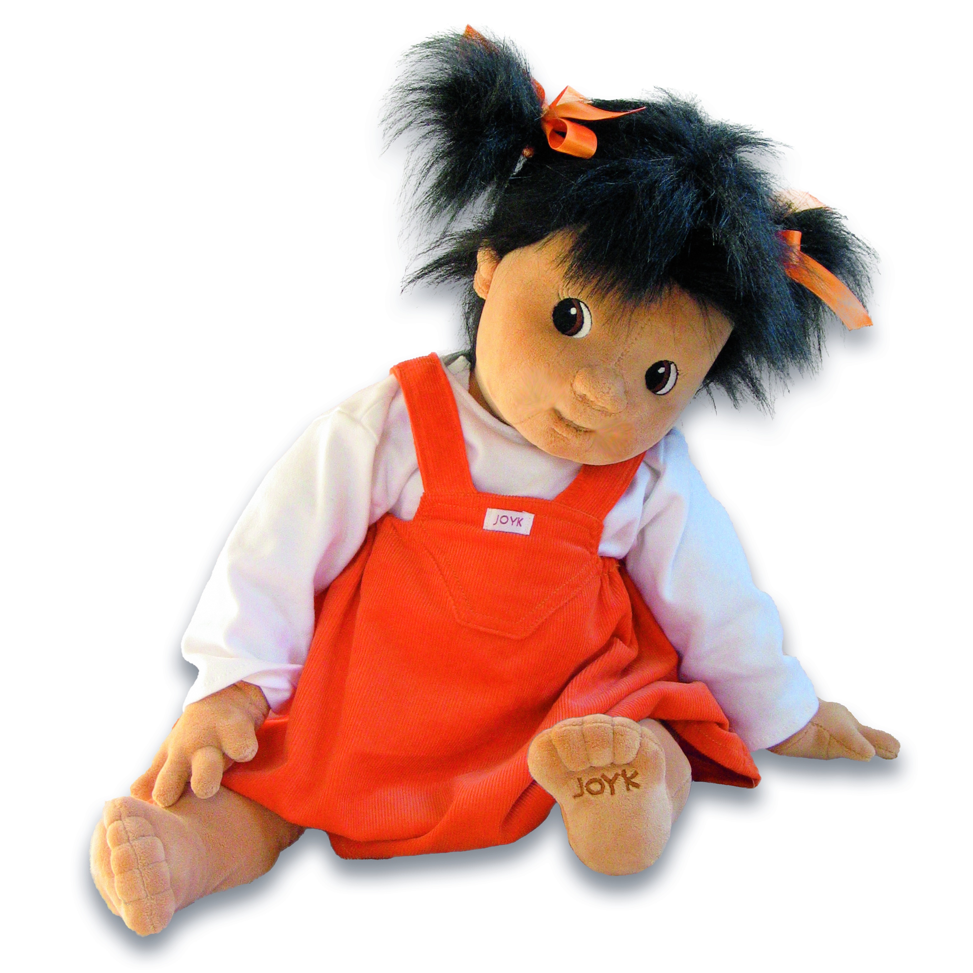 Joyk empathy doll Emelie with dark pigtails, white shirt and orange pinafore dress, sitting