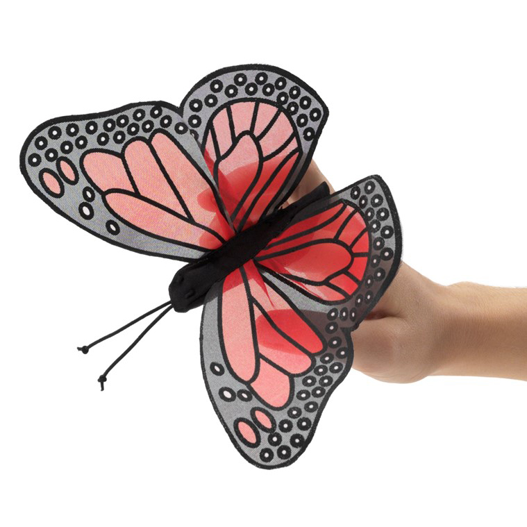 Folkmanis mini monarch butterfly finger puppet with red and black wings on an outstretched finger, side view