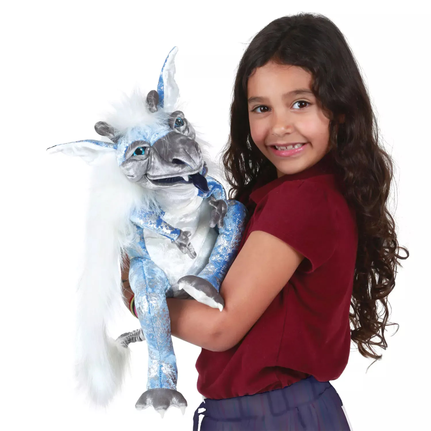 Girl holding the Folkmanis Ice Dragon hand puppet with blue-silver fur, white mane trim and horns in her arms