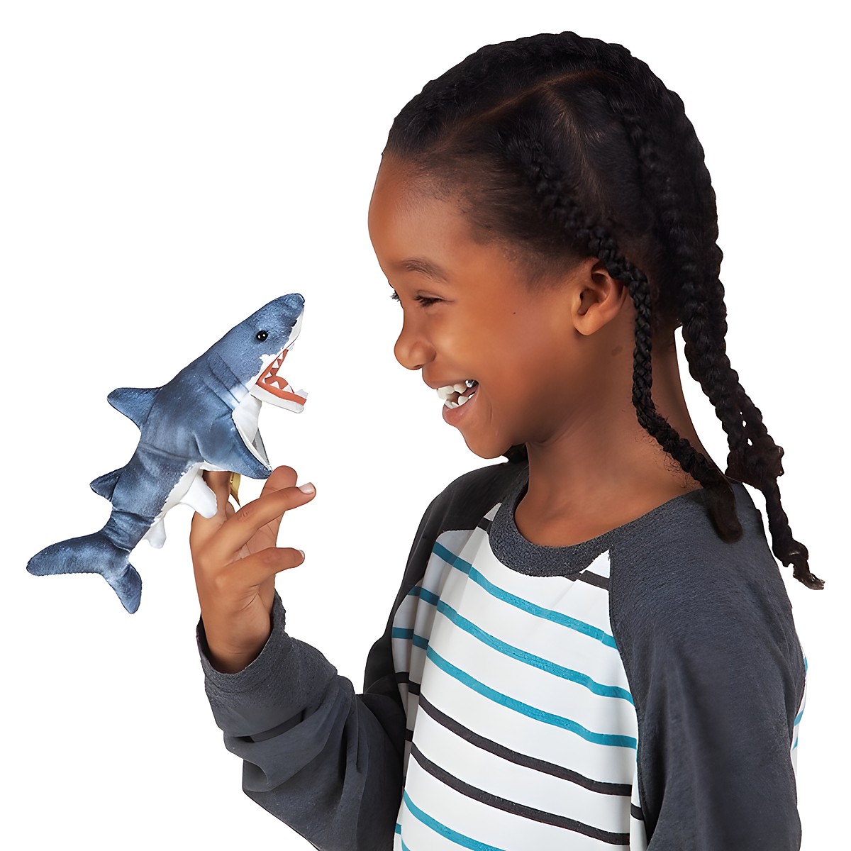 Child laughing while wearing a Folkmanis mini shark finger puppet in blue-grey with open mouth on their index finger