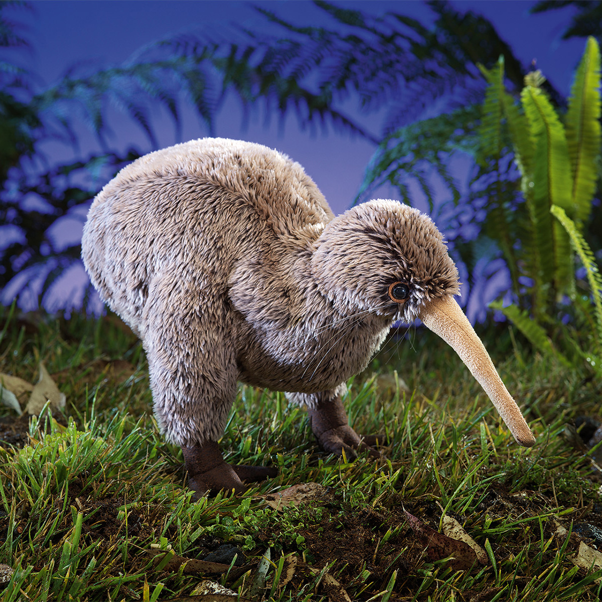 Folkmanis kiwi hand puppet with brown plush feathers and a long beak, shown in side view on grass against a blue background