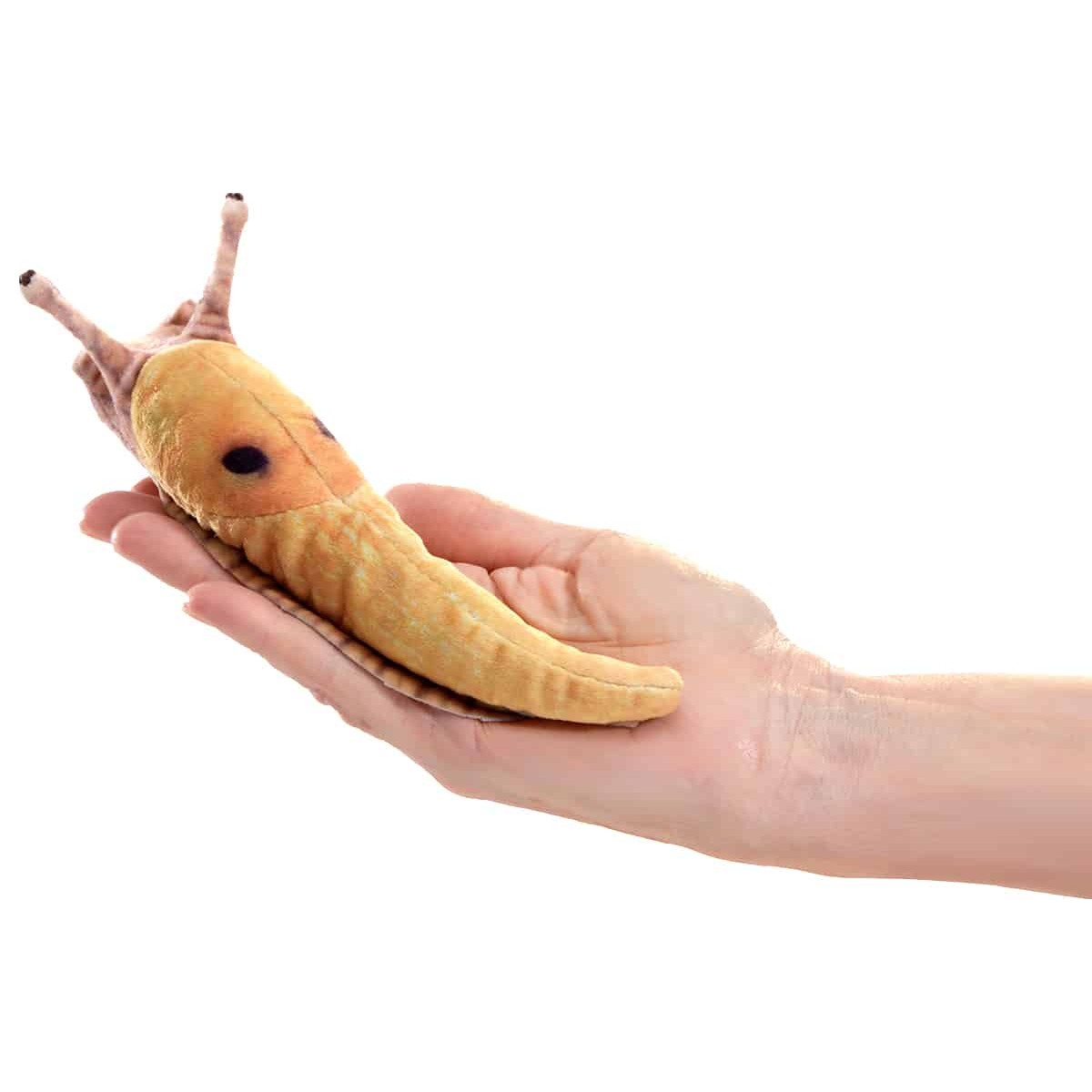 Folkmanis mini banana slug finger puppet in yellow-brown lying on an open palm, side view