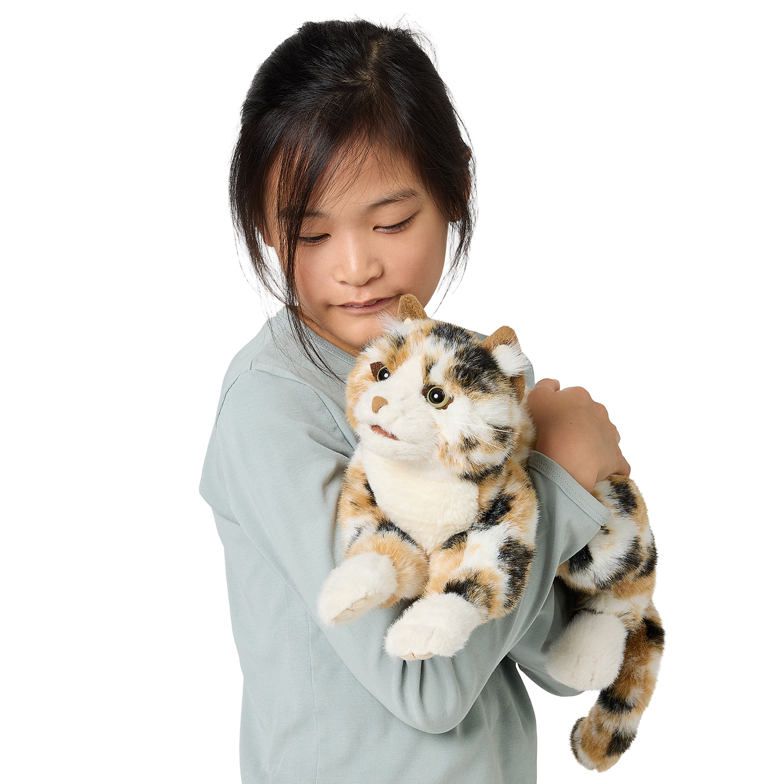 Girl holding the Folkmanis calico cat hand puppet with tricolour tortoiseshell fur and green eyes in her arms