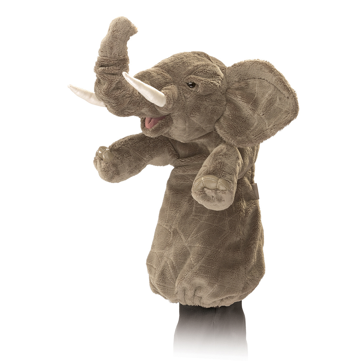 Folkmanis elephant hand puppet made of grey plush with raised trunk, white tusks and ears spread to the sides, worn on a hand