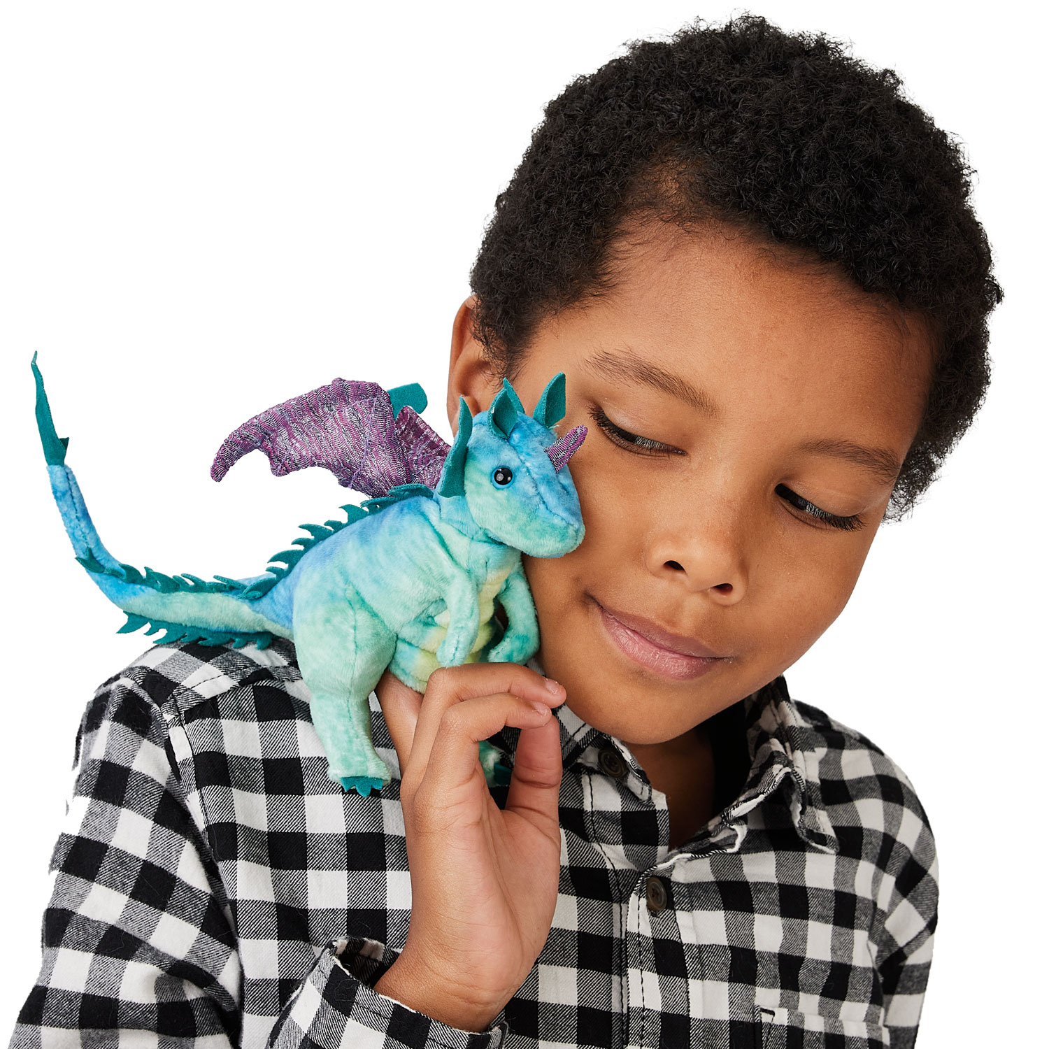 Folkmanis mini dragon finger puppet in teal green with purple wings, held against a child's cheek