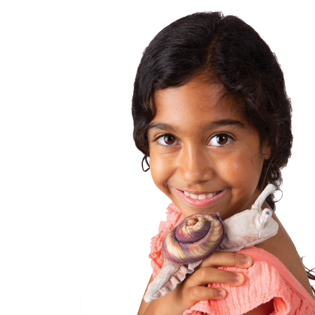 Smiling girl holding the Folkmanis mini snail finger puppet with swirled purple shell on her shoulder.