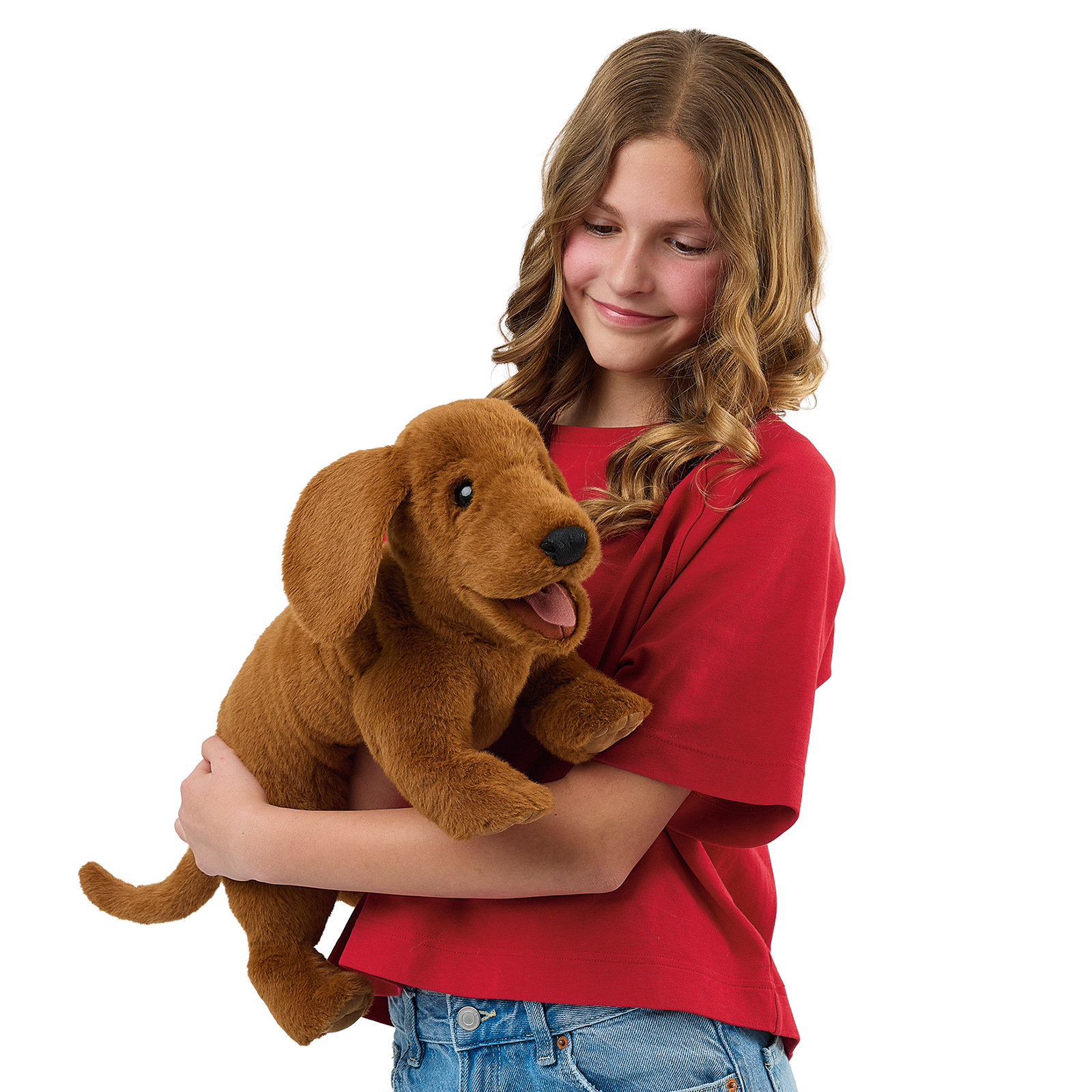 Folkmanis dachshund hand puppet held close to a girl's chest, its mouth slightly open.