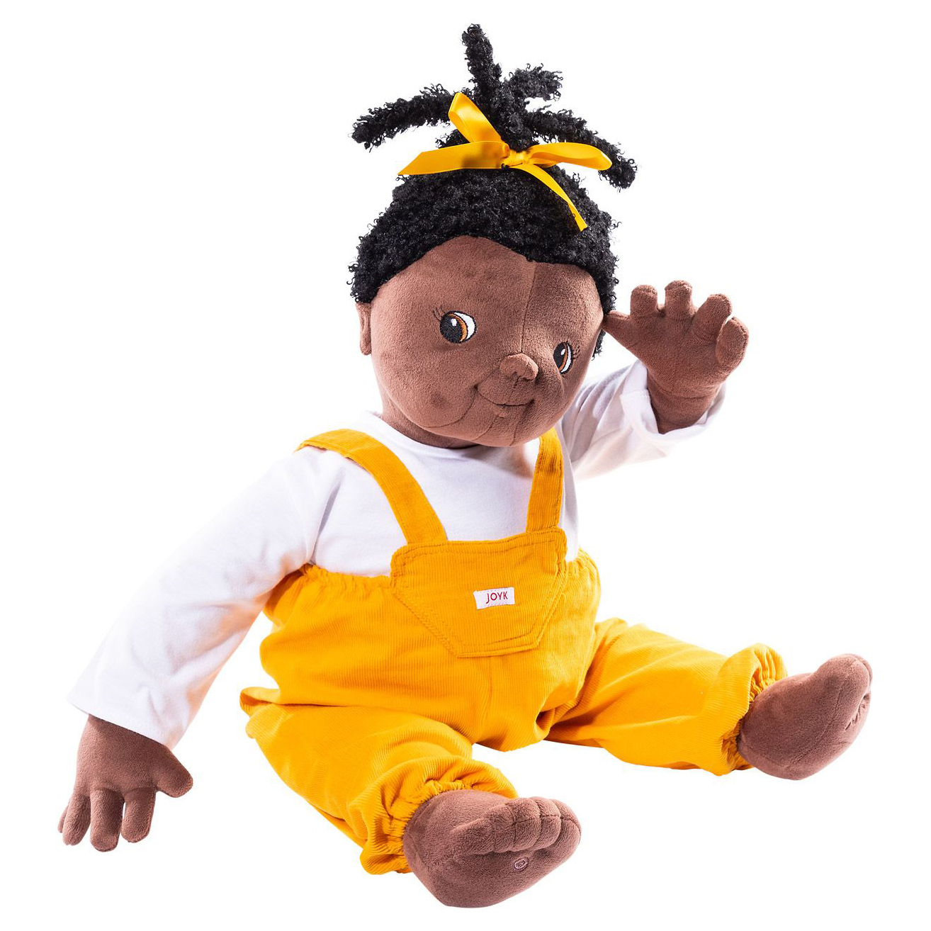 Joyk empathy doll Sofia with black pigtail, yellow bow, white shirt and yellow dungarees