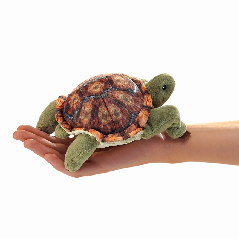 Folkmanis mini tortoise finger puppet with a detailed printed shell in brown tones, lying on an open hand