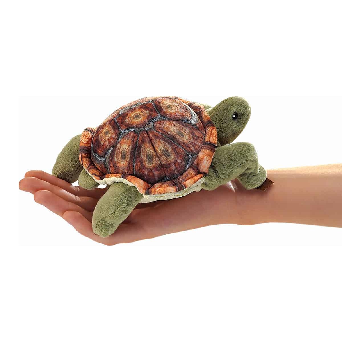 Folkmanis mini tortoise finger puppet with a detailed printed shell in brown tones, lying on an open hand