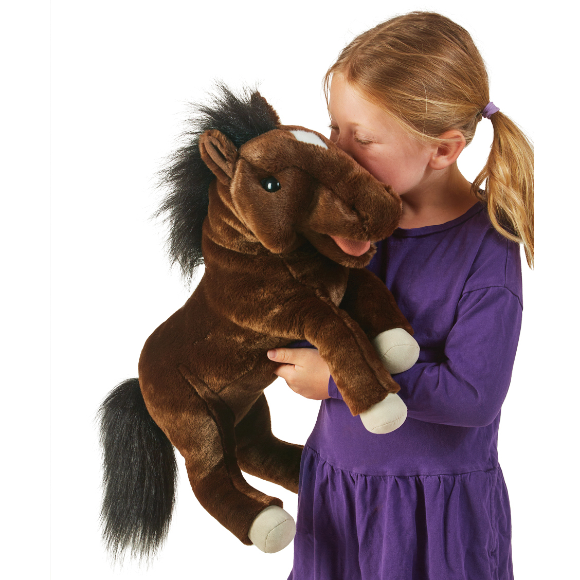 Girl holding and kissing the Folkmanis horse hand puppet in dark brown with a black mane and light blaze