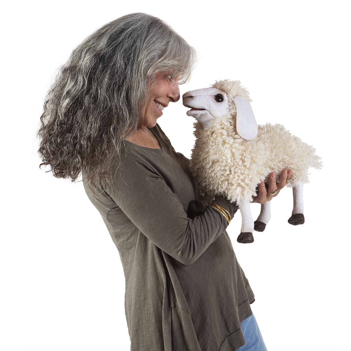 Folkmanis hand puppet woolly sheep with cream curly fleece, held by a smiling woman shown in side view