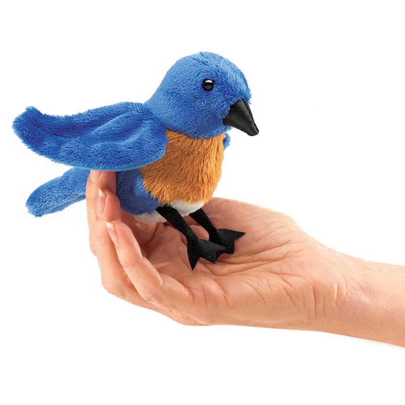 Folkmanis Mini Bluebird finger puppet in blue and rusty brown, sitting on an open hand, side view