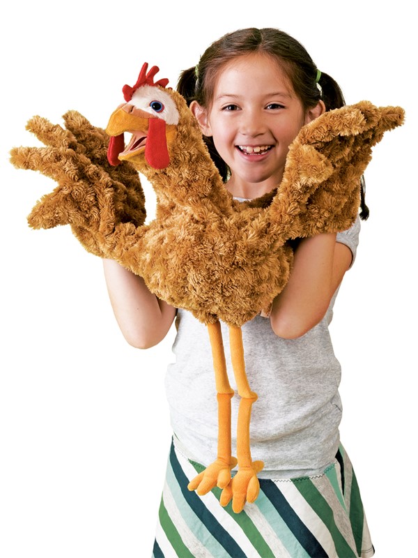 Girl operating a large Folkmanis chicken hand puppet with brown curly plush, red comb, and yellow legs using both hands