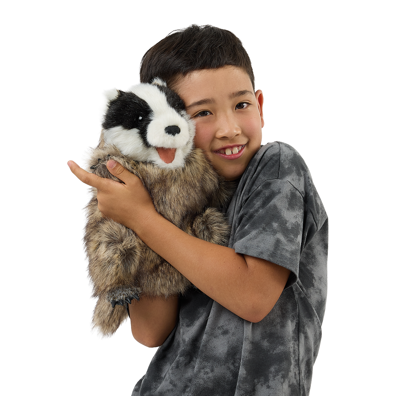 Folkmanis badger hand puppet on a boy's arm, its mouth opened wide with the pink tongue clearly visible.